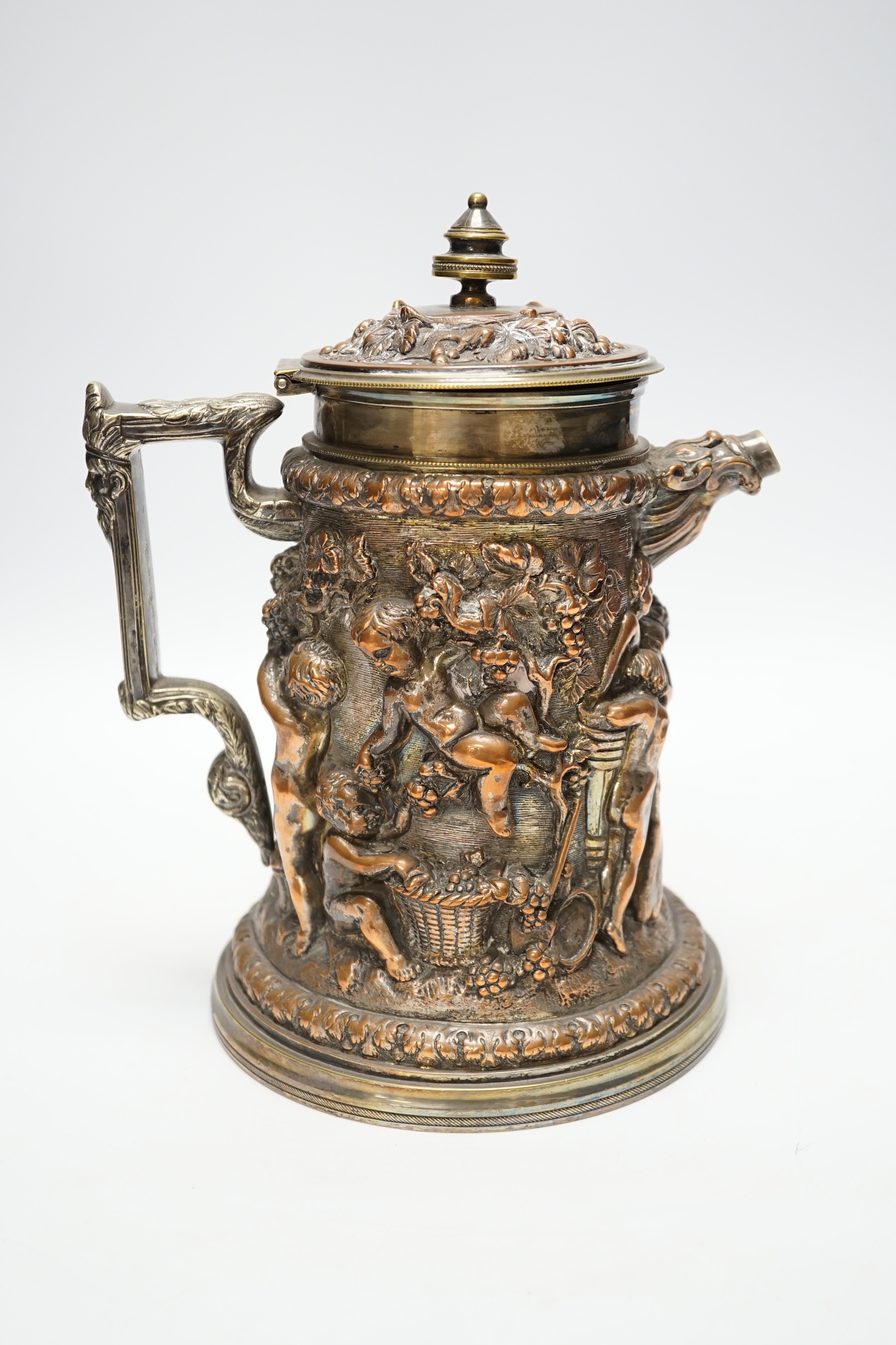 A Victorian electrotype relief putti jug with hinged cover. 24cm high